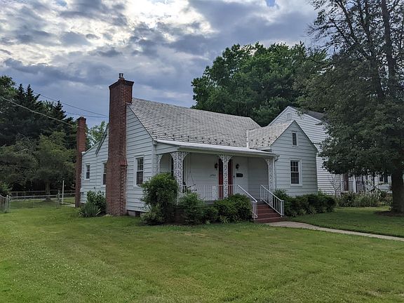 Side of home, large lot. Driveway is in the back.