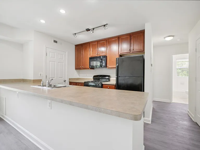 Gourmet designer kitchens with stainless steel appliances, track lighting, quartz countertops, and Italian kitchen cabinetry
