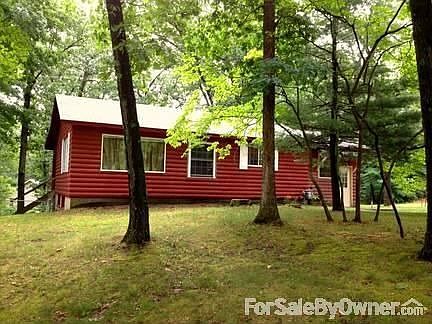 Front of log home in wooded lot