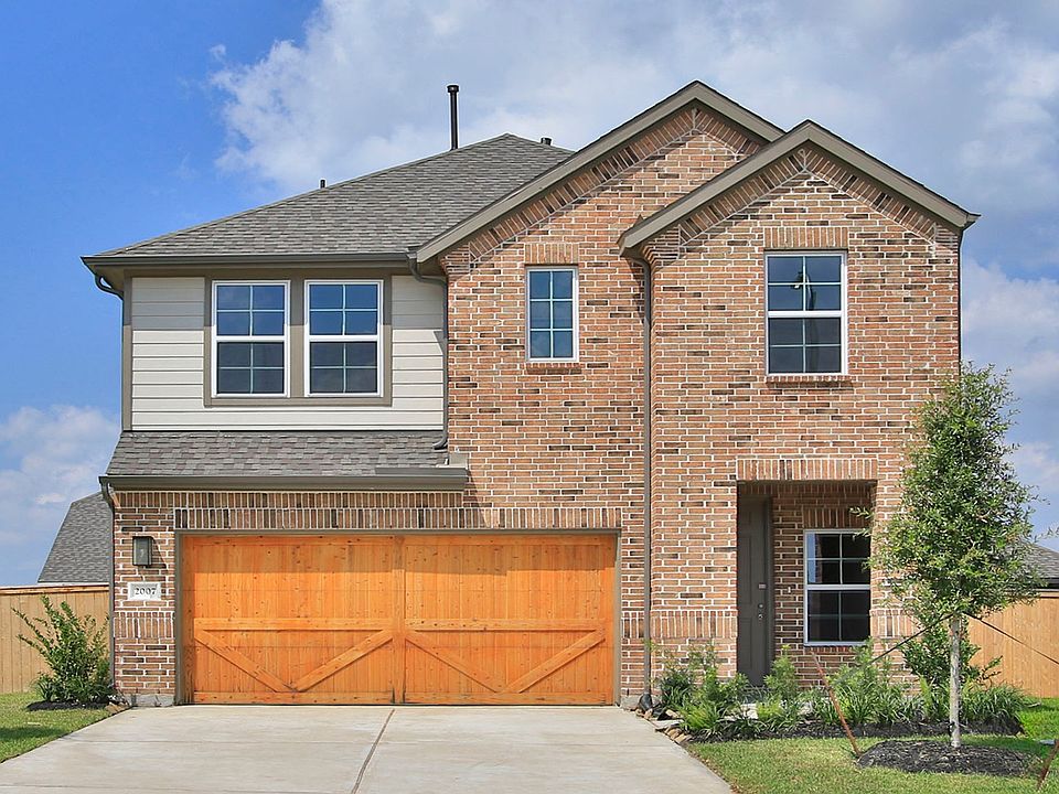 Timeless brick facade, expansive windows, and a gable roof elevate this Eldridge home to high archit