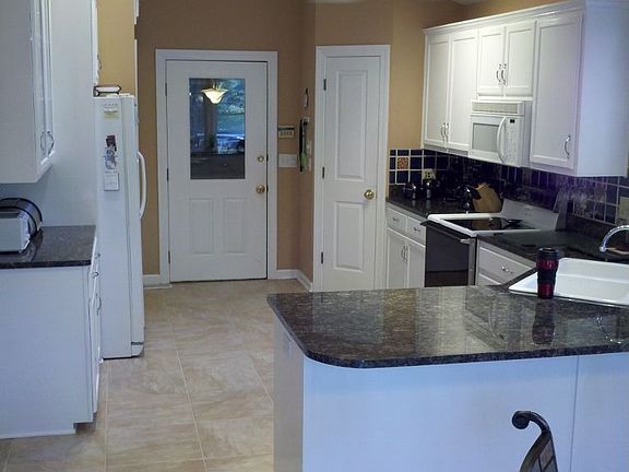 Kitchen with granite countertops and skylights