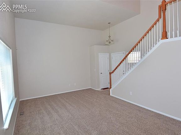 Living room with vaulted ceiling and new carpet