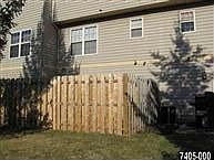 Back of the Home with Fenced in Yard