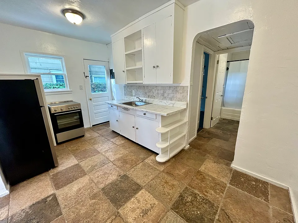 Kitchen includes new refrigerator and oven.