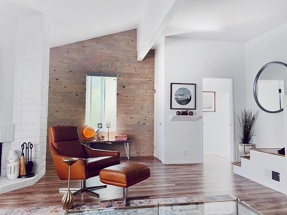 Front door entry to open floor plan living room, with beautiful sunshine.