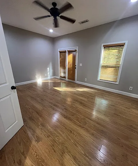 Large master bedroom with ample closets and access to private screened porch.