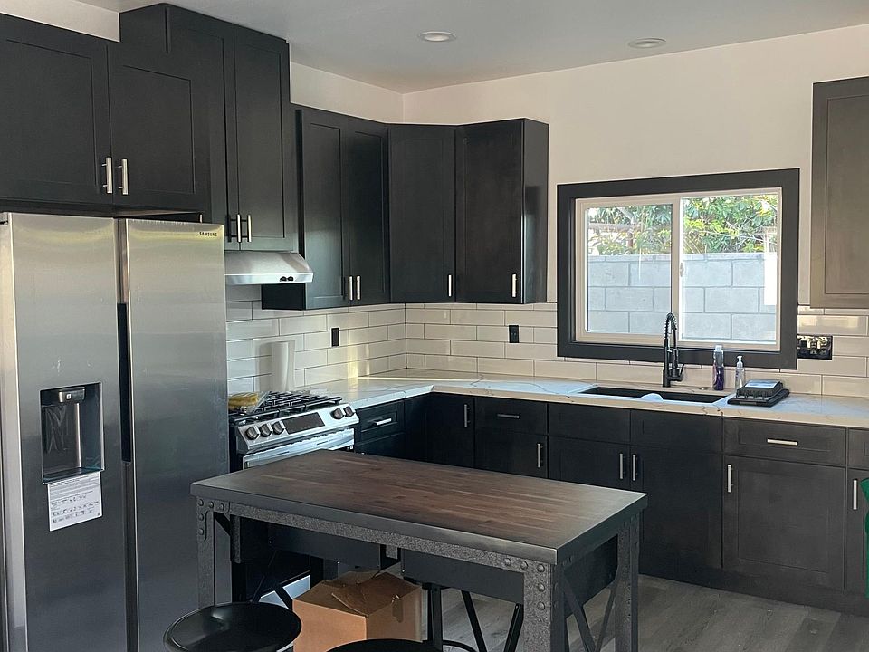 Beautiful Brand New Kitchen. Black Cabinets and white granite countertops