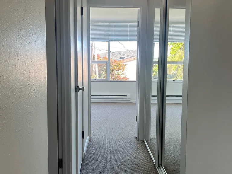 Hallway, bathroom on the left and two closet/storage spaces.
