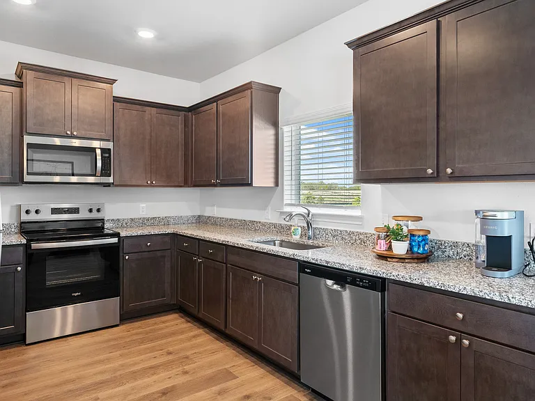 The kitchen has beautiful wood cabinetry.