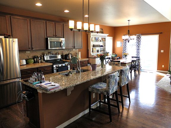 Gourmet kitchen with gas range and stainless steel appliances.