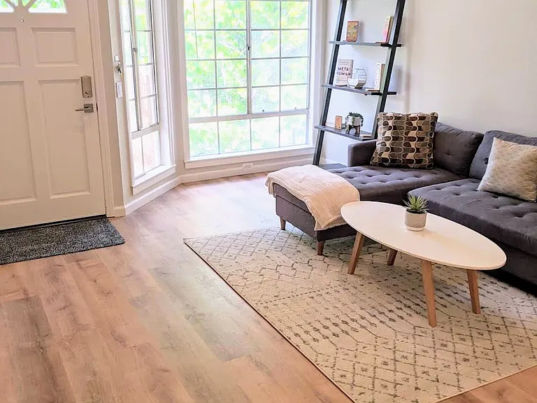 Living Room with vaulted ceilings, large windows, natural light, new floors