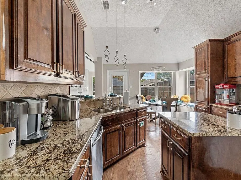 Kitchen with granite counters, stainless steel appliances including refrigerator (full fridge and freezer), dishwasher, conduction stove, oven, microwave, ice maker, sink has disposal, cabinets with undermount lights for ease and elegance. Plenty of count