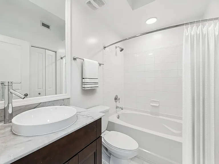 Renovated Package II bath with quartz countertop and oak cabinetry (in most homes)