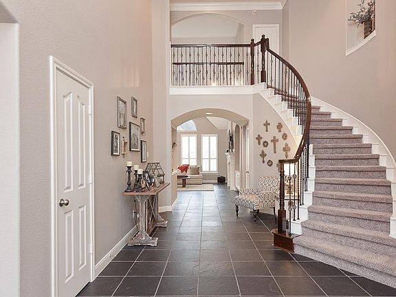 From the moment you enter into this home your guests will be "WOWED" with the soaring ceiling, art niche on the stairwell, wrought iron railing and slate floors.