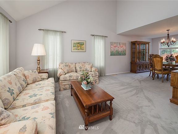 Formal living room with vaulted ceilings and bright windows