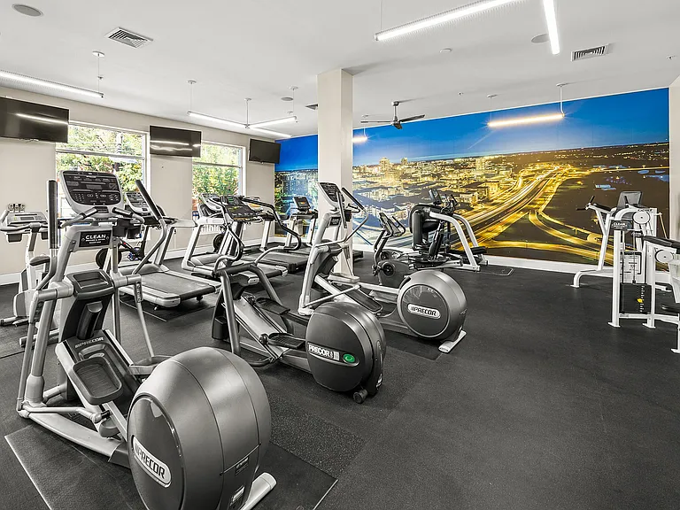 Stay fit in style at our state-of-the-art fitness center, equipped with advanced machines and a vibrant city view.