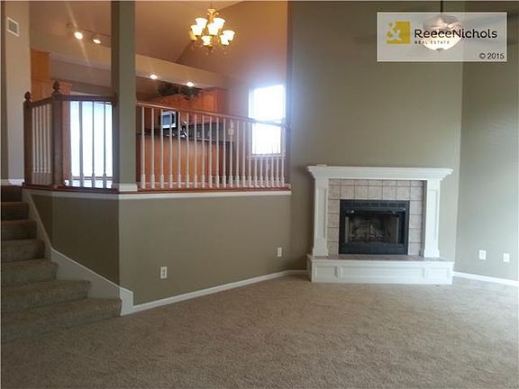 Living Room with Wood-Burning Fireplace and Large Ceiling Fan