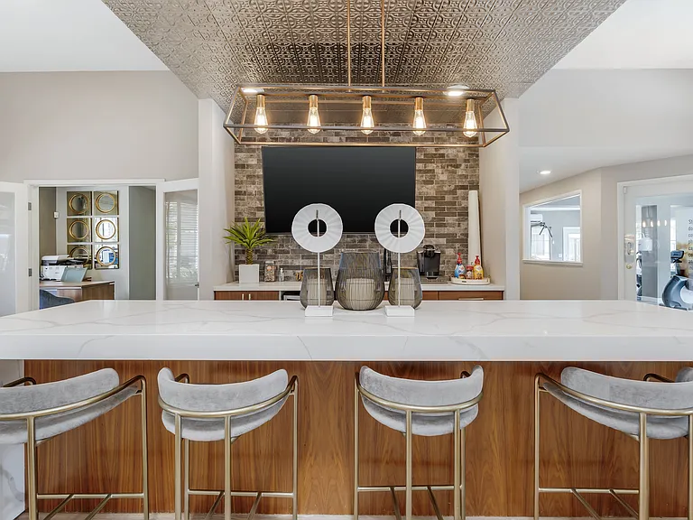 The clubhouse coffee bar offers refreshing drinks, with a large TV nearbycreating a cozy spot for residents to relax, socialize, and enjoy entertainment together.