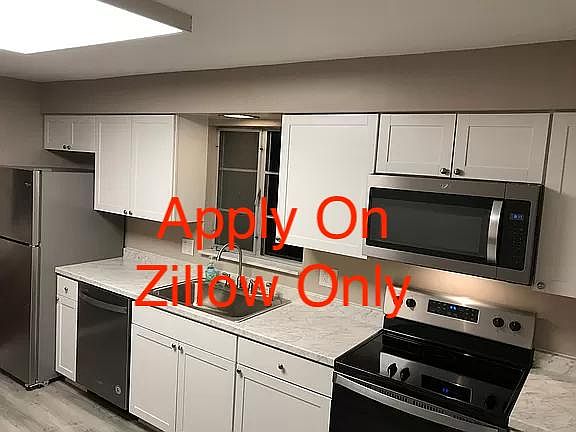 New Kitchen with shaker cabinets, stainless appliances including microwave oven and dishwasher.