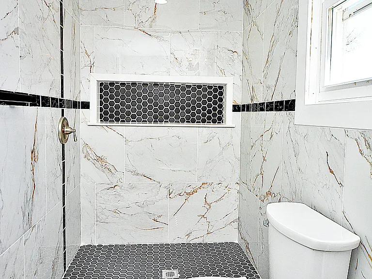 Bathroom - modern newly renovated with tiled walls and shower stall with large wall niche.