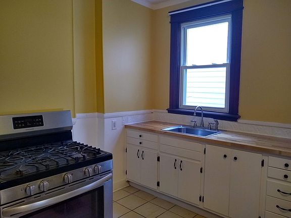 kitchen with butcher block countertop and stainless steel range and refrigerator