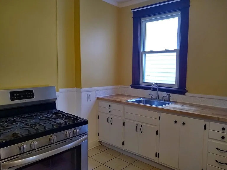 kitchen with butcher block countertop and stainless steel range and refrigerator