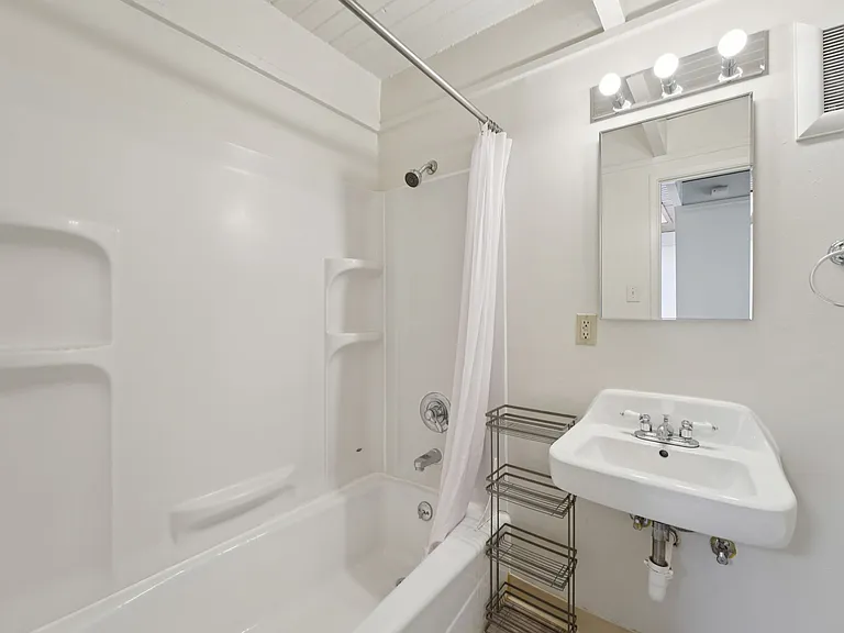 Townhouse bathroom with full shower and bathtub.