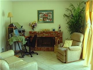 Spacious family room, brick fireplace,slider to covered patio and pool.