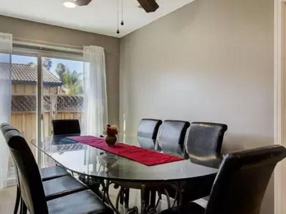 The dining room has fresh, bright lighting. The sliding door allows for easy access to the side yard & the backyard.