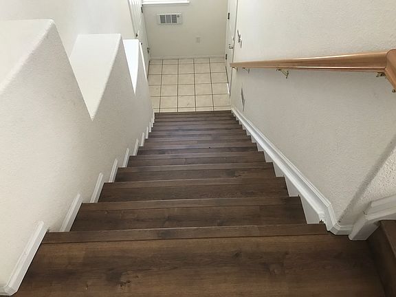 Stair entry - landing below has door to garage on right - and to front door is on left