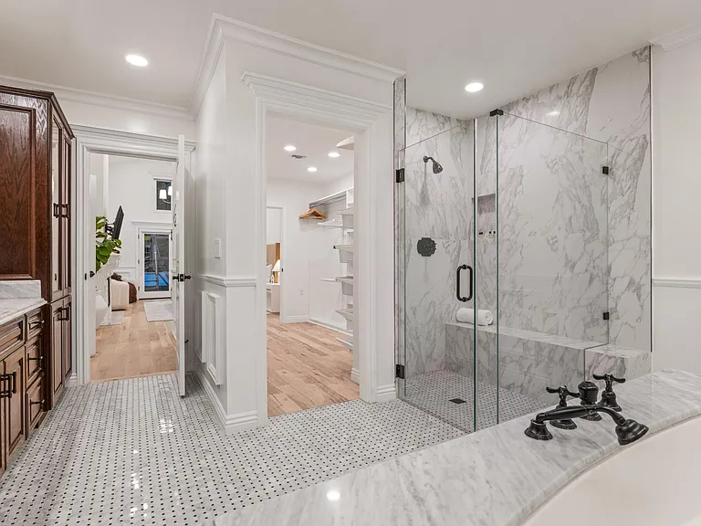 Embrace luxury in the ensuite bathroom, a private haven with a chic glass walk-in shower.