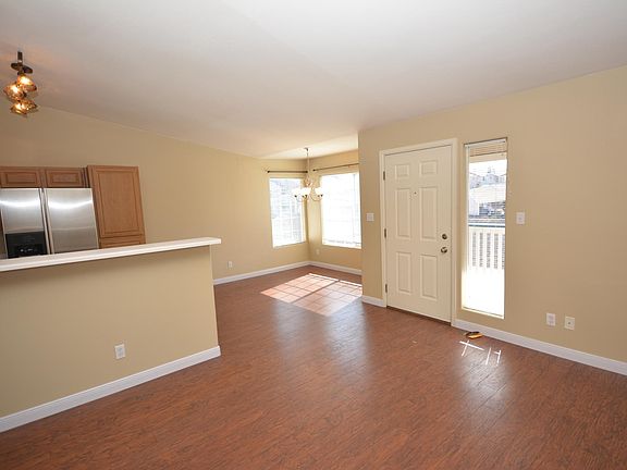 Open living room, dining room and kitchen area with laminate
