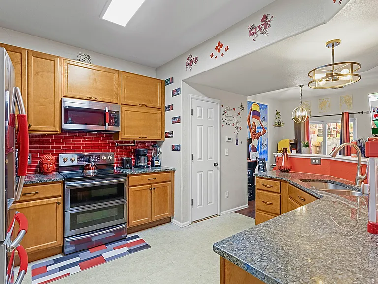 Spacious and well-equipped kitchen with modern appliances and plenty of counter space. Perfect for cooking up a feast or enjoying a quick meal.