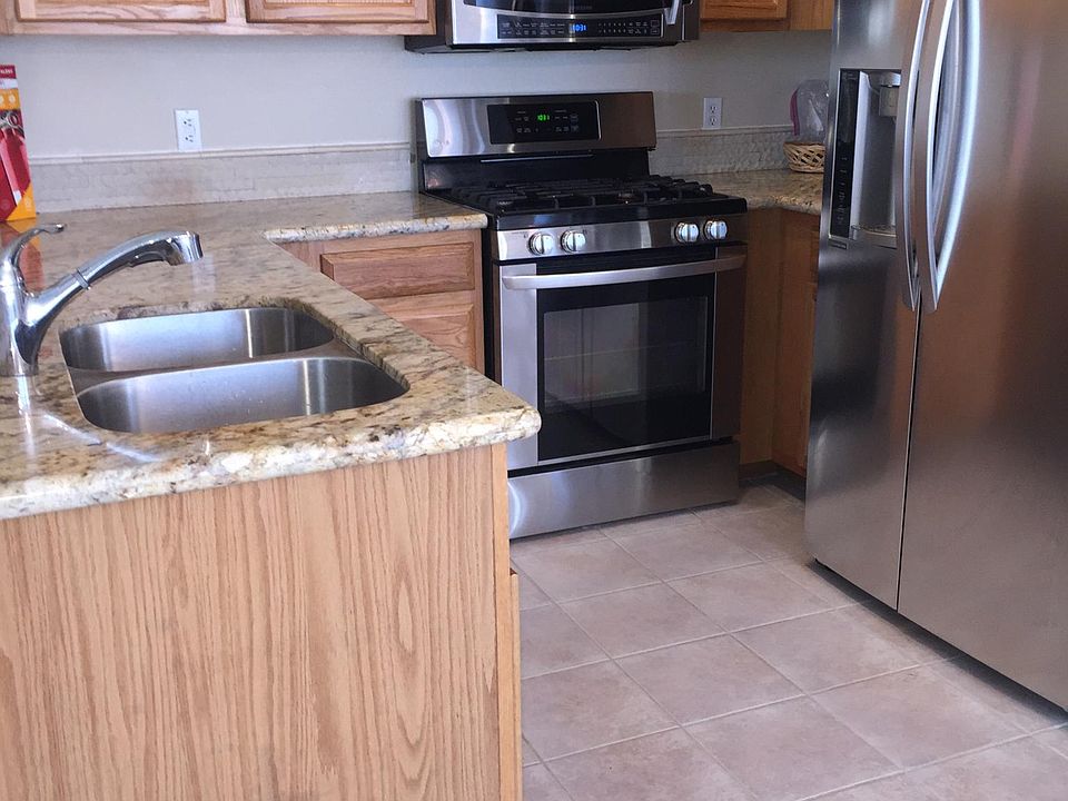 Stainless kitchen with gas stove and granite counters