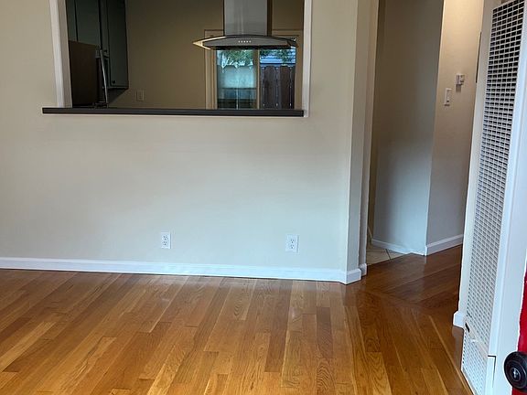 Living Room with Kitchen Bar and new track lighting and refinished hardwood floors