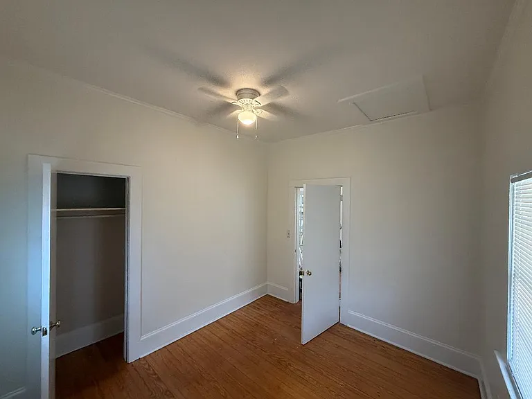 Front bedroom with closet on the left and door back to living room.