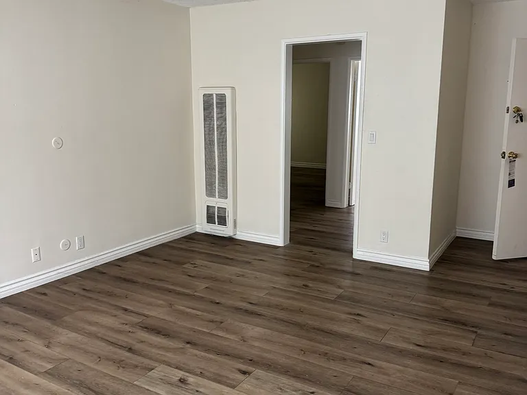 Living room showing the entrance to the small hallway where entrance to 2 bedrooms and bathroom.