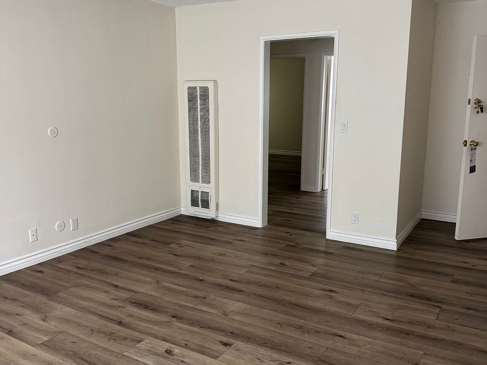 Living room showing the entrance to the small hallway where entrance to 2 bedrooms and bathroom.