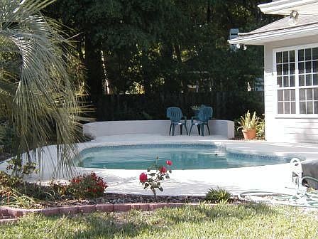 Solar heated pool in privacy fenced backyard