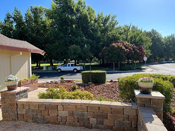 Looking out from the kitchen bay window east toward Silverado Park.
In the foreground is the courtyard with firepit. 
Shrubs just over the stone wall are recently trimmed tea roses. 
The Rose Garden is under the kitchen sink window around to the south.