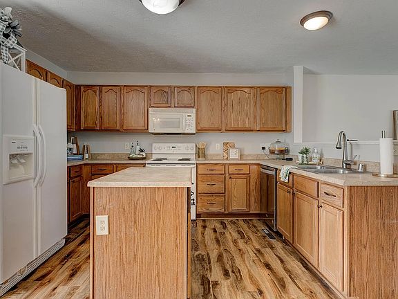 Spacious kitchen equipped with ample cabinet storage and an island.