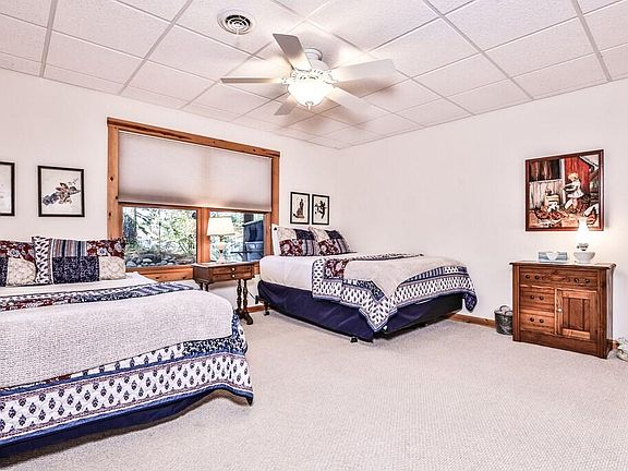 Third bedroom with two Queen Beds, lake views. Its on lower level off Family Room, laundry room, and walkout to back patio.