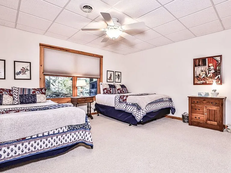 Third bedroom with two Queen Beds, lake views. Its on lower level off Family Room, laundry room, and walkout to back patio.