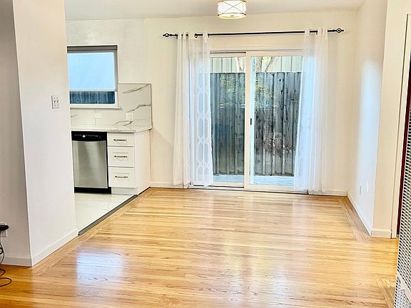 Dining room with access to the backyard, double layer windows throughout the unit