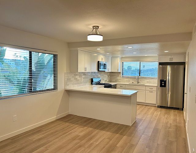 New custom kitchen with bar counter top, and dining room