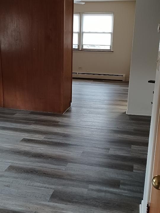Living area divided by large storage closet.