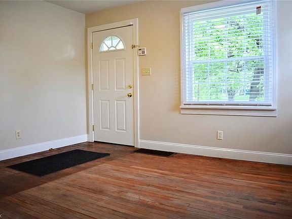 The living room measures 13x13. The exposed hardwood floors can be finished or carpeted. Lots of natural light comes through the
