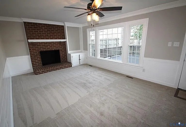 Rear facing 2nd living room overlooking the massive deck! Tons of natural lighting