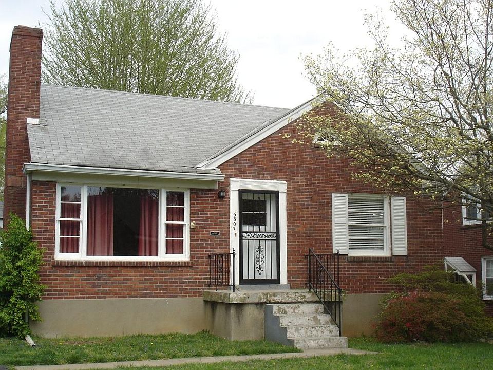 brick home with long driveway and nice front and back yard