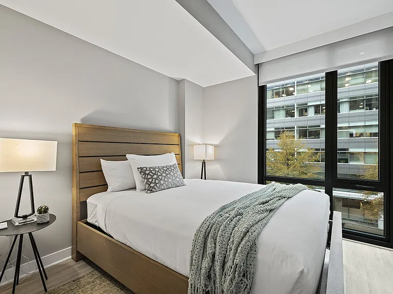 Spacious bedroom with floor-to-ceiling windows.